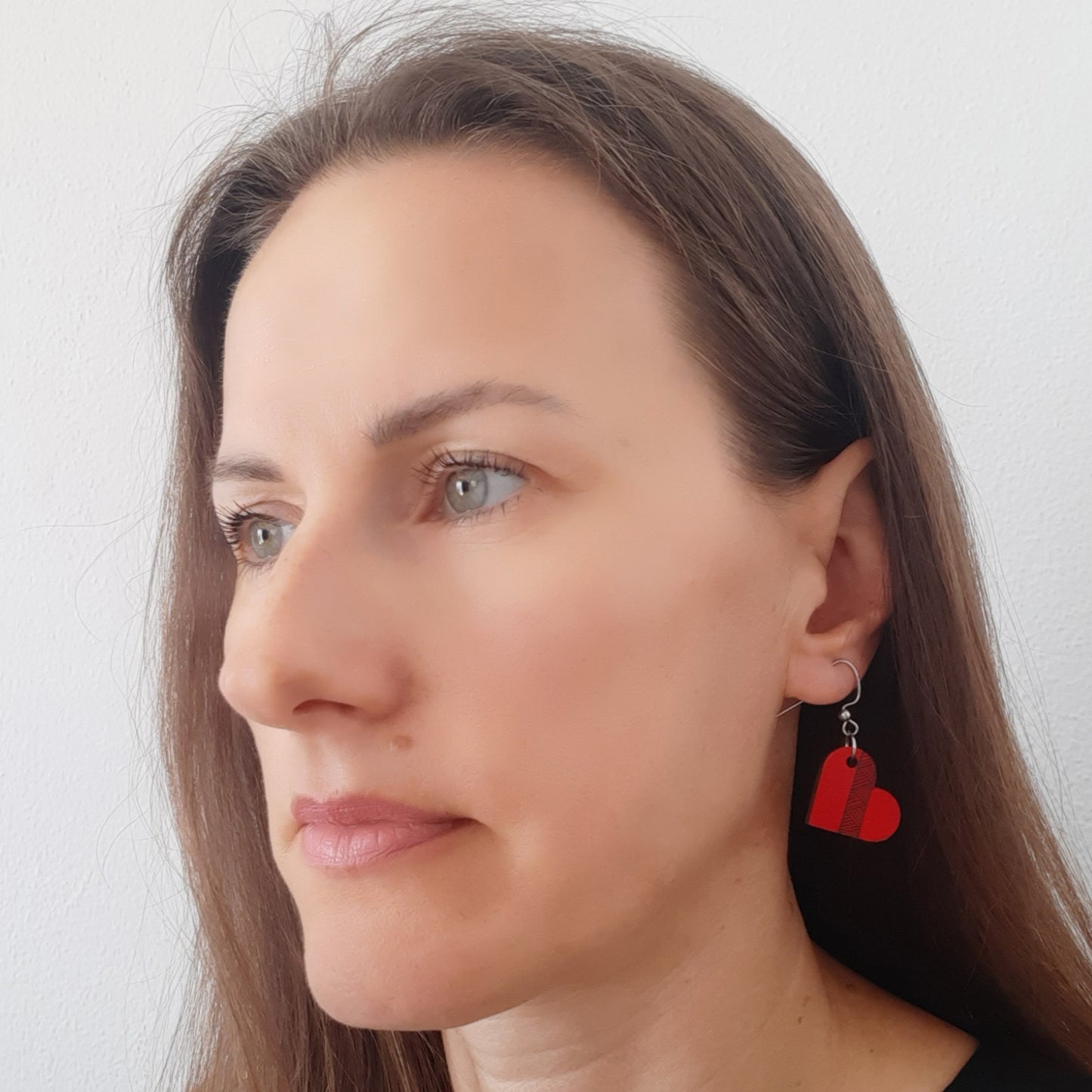 Small red unique wooden earrings in the shape of a heart