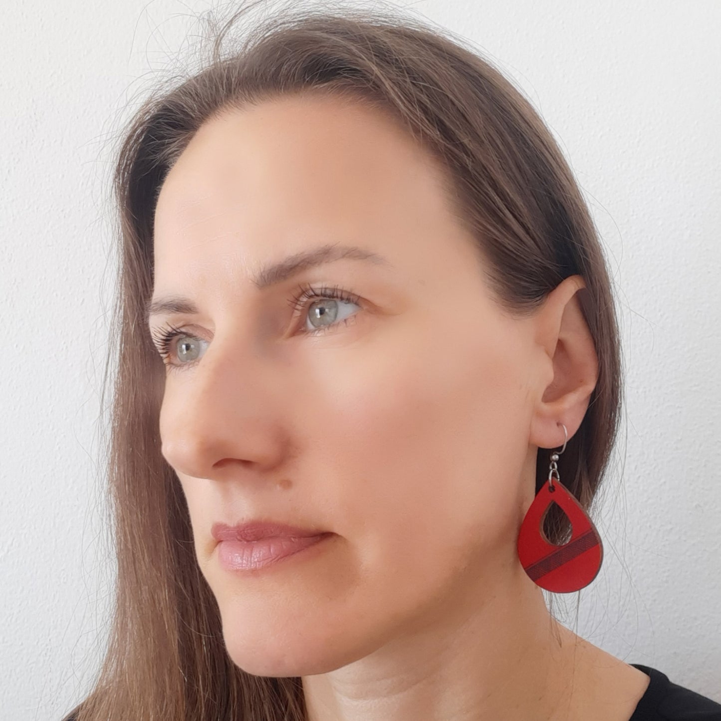 Unique red wooden earrings in the shape of a teardrop