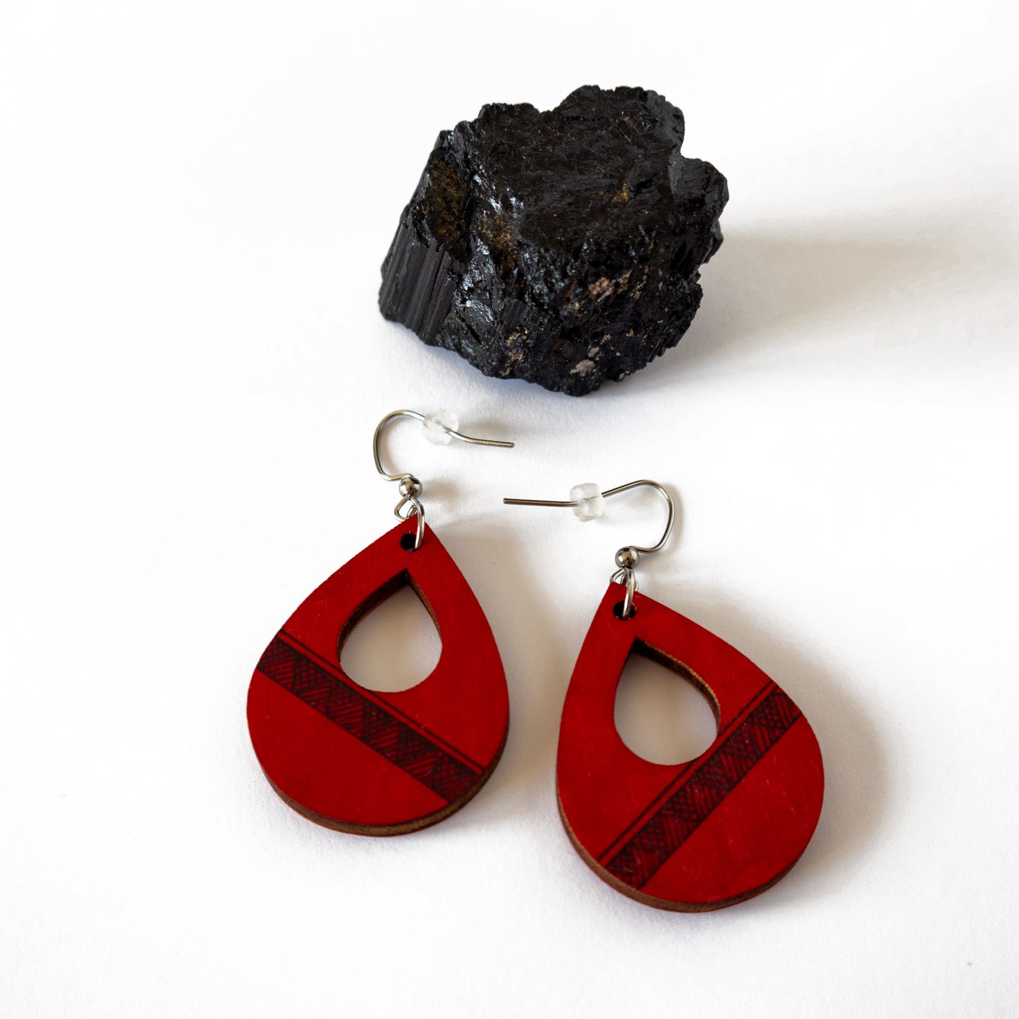 Unique red wooden earrings in the shape of a teardrop