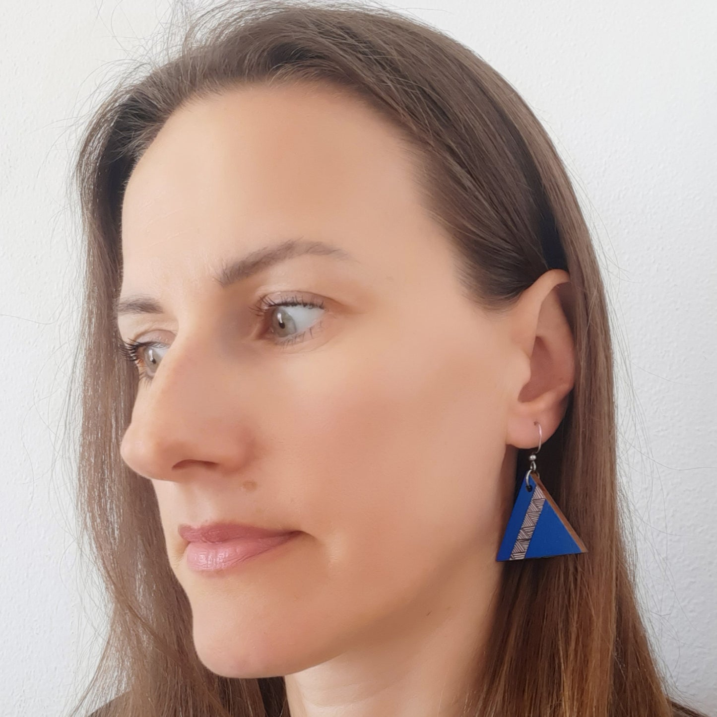 Unique blue wooden earrings in the shape of a triangle