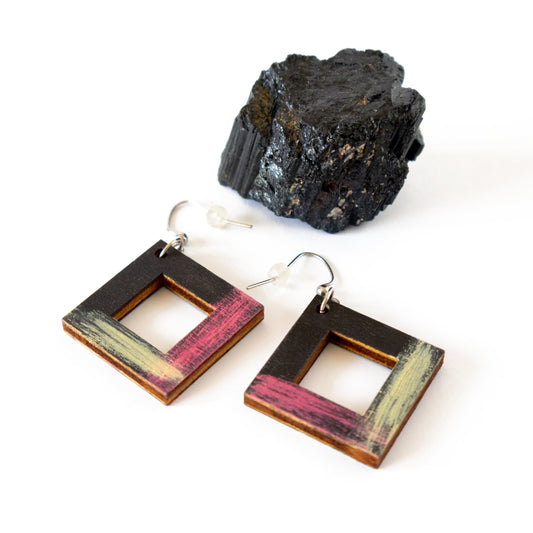 Unique black wooden earrings with pink and yellow details