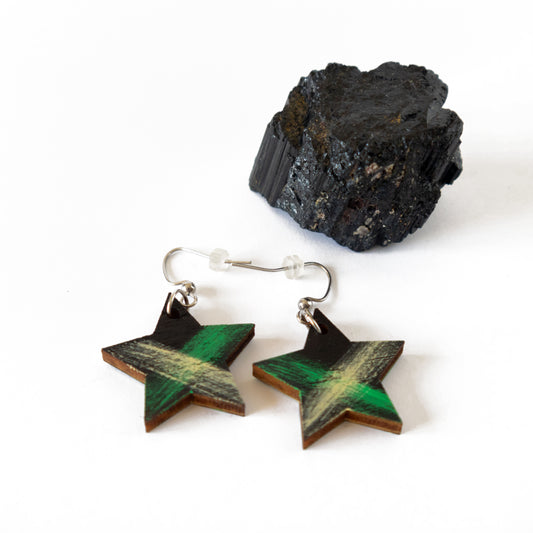 Star shaped black wooden earrings with green and yellow details