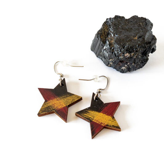 Black star shaped unique wooden earrings with red and gold details