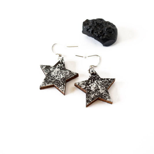 Star shaped black wooden earrings with silver details