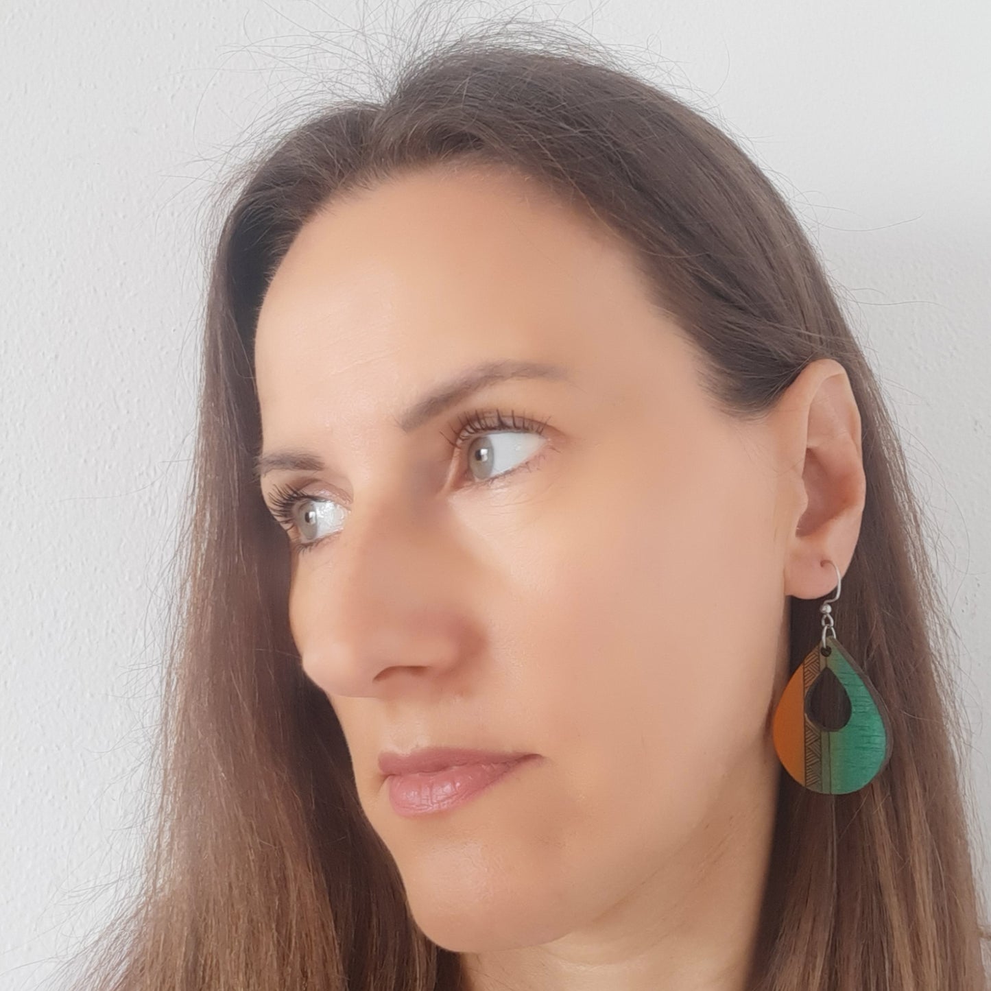 Green-orange unique wooden earrings in the shape of a teardrop