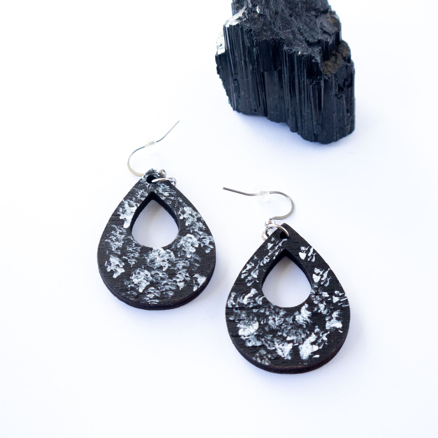 Black and white unique wooden earrings in the shape of a teardrop